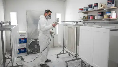 Professional cabinet painting process in Troy, MI using spray and brush for smooth, durable kitchen finishes