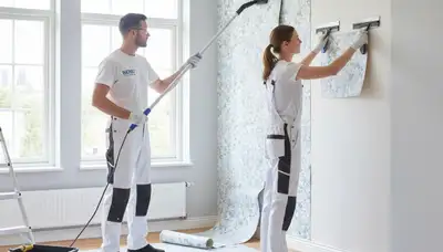 Professional wallpaper removal service by house painters in Troy, MI preparing walls for painting